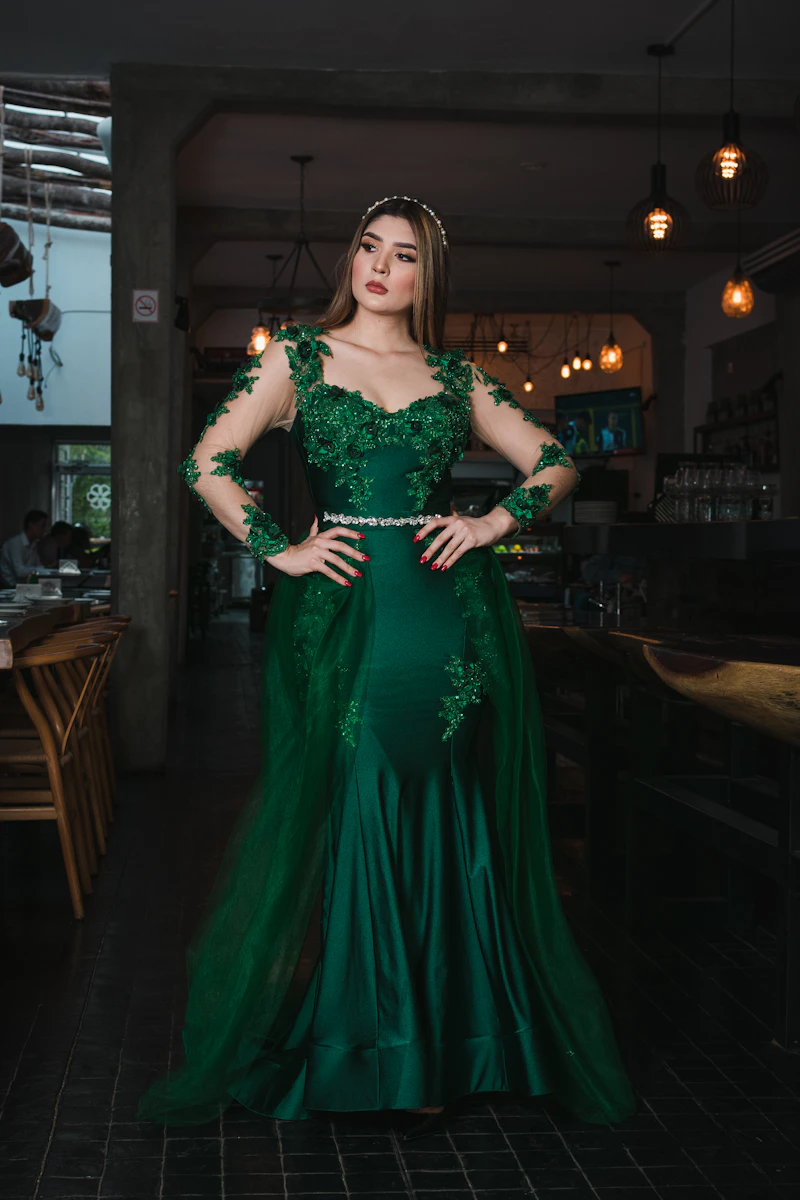 Model wearing an embroidered sage green lehenga
